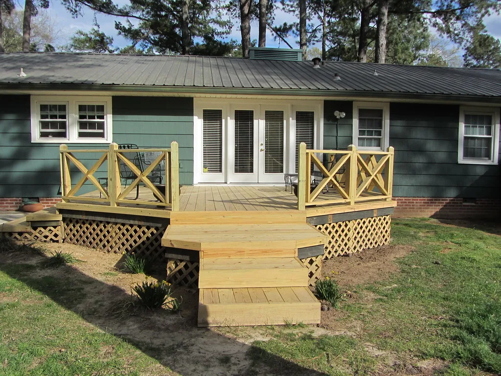 New deck with wide steps and X-pattern railings