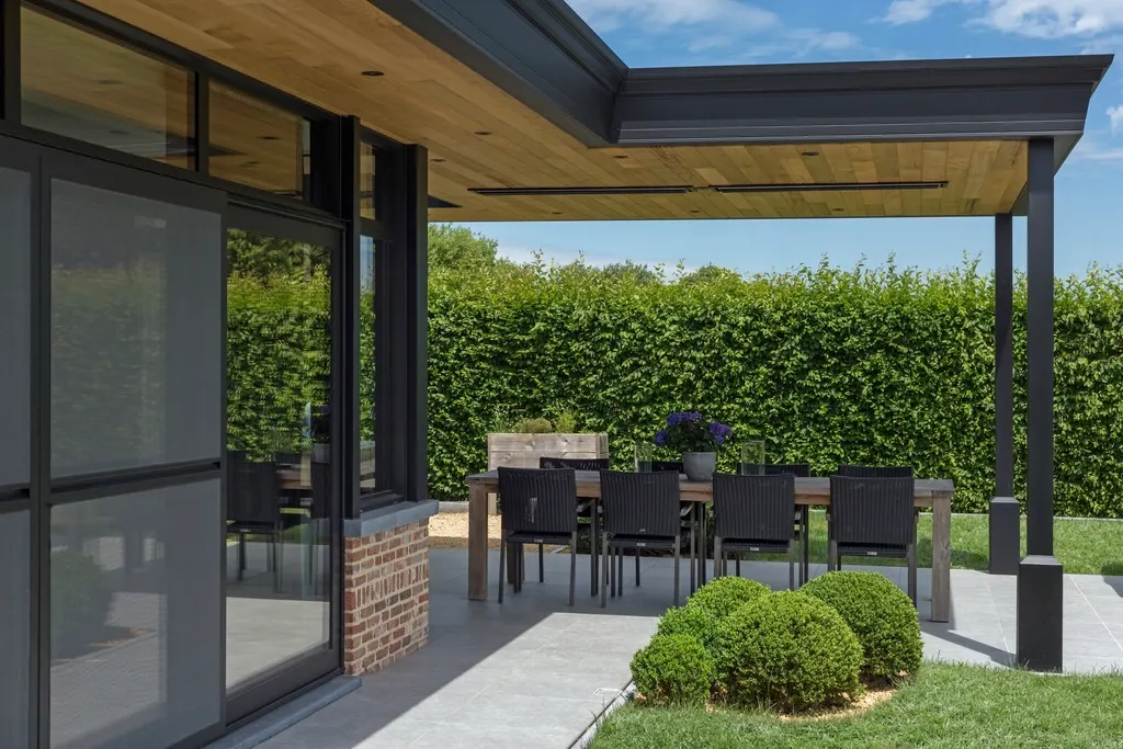 Modern covered patio with a solid roof over an outdoor dining table